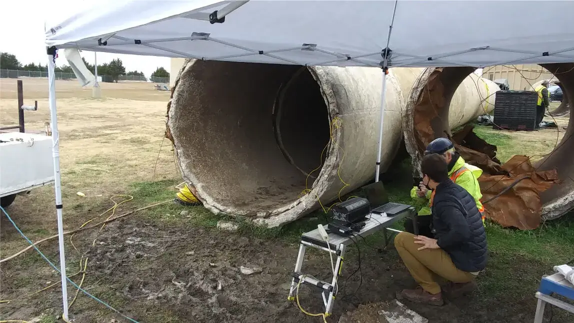 On-site training for installation of sensing fiber on concrete pipe to characterize failure modes on distressed pipe